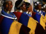 Neck-stretching brass coils announce marrigage as do a beaded jocolo wedding apron that mirrors the primary colors of the decorations hand painted by the mguni-speaking Ndebele.