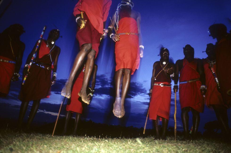Rhythmic chanting provides a syncopated beat for the blood drinking Maasai whose traditional dance is this observational opportunity for getting a leg up on approuching wildlife.  Maasai Mara, Kenya