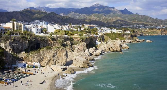 Scenic resort town of Nerja with small sandy beach on Costa del Sol by the Mediterranean Sea in Spain, southern Andalusia region, Malaga province. 