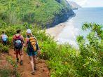 Hikers on the famous Kalalau Trail on the north shore of Kauai. The 11-mile trail that leads from Ke'e Beach to Kalalau Beach on the Na Pali coast.