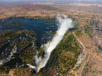 Victoria Falls (or Mosi-oa-Tunya - the Smoke that Thunders) waterfall in southern Africa on the Zambezi River at the border of Zambia and Zimbabwe. Aerial Image taken from helicopter flight